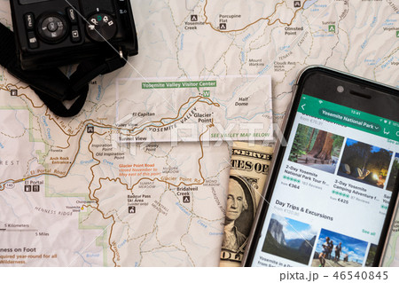 Travel accessories, camera, smart phone, folded one Dollar bill and travel map, detail of Arizona Travel accessories, camera, smart phone, folded one Dollar bill and travel map, detail of Arizona 46540845