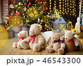 Family of teddy bears siting under the christmas tree with presents 46543300
