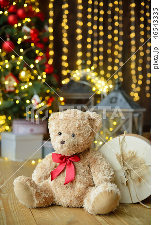 Teddy bears siting under the christmas tree with presents 46543335
