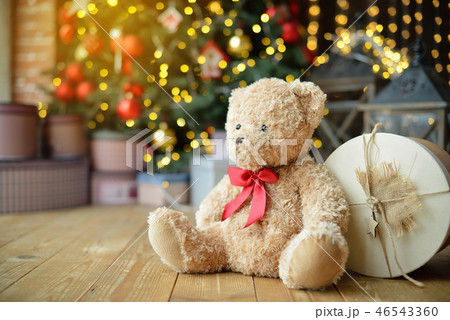 Teddy bears siting under the christmas tree with presents 46543360