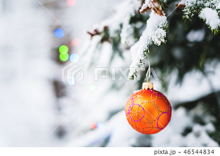 Close-up of a Christmas toy on a snow-covered lively tree in the winter forest on the background of Close-up of a Christmas toy on a snow-covered lively tree in the winter forest on the background of 46544834