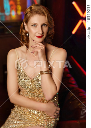 Beautiful young girl in golden evening dress Beautiful young girl in golden evening dress 46549253