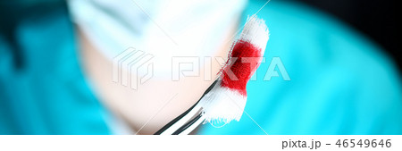 Surgeon in sterile uniform arms holding tools with bio material 46549646