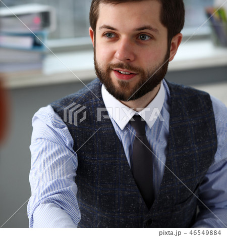 Man in suit and tie give hand as hello in office Man in suit and tie give hand as hello in office 46549884