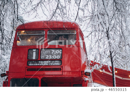 Loving young couple kissing in the red bus, enjoy each other Loving young couple kissing in the red bus, enjoy each other 46550315