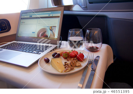 SINGAPORE, - JULY 22, 2016: delicious cheese, red wine and working on a laptop in Business Class an 46551395