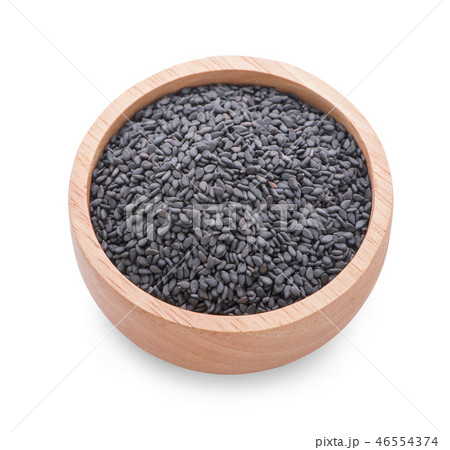 Black sesame in a wooden cup on a white background Black sesame in a wooden cup on a white background 46554374