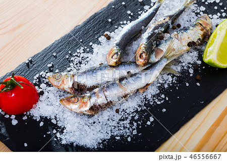 Deliciously dish of anchovy baked in the oven on a pillow of sea salt Deliciously dish of anchovy baked in the oven on a pillow of sea salt 46556667