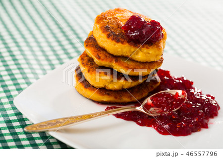 Image of stack of fried quark pancakes with jam served 46557796