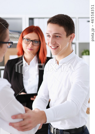 Smiling man in suit shake hands as hello in office 46558351