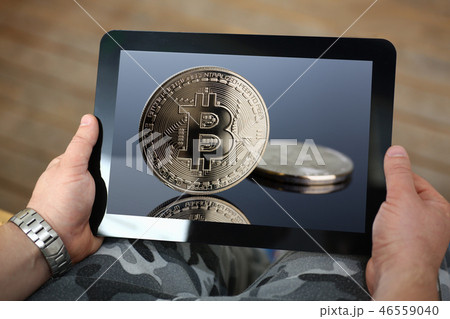 Hipster arms hold tablet pc with btc sign coins 46559040