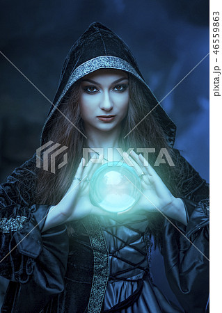 The witch with magic ball in her hands causes a spirits 46559863