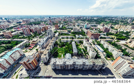 Aerial city view with crossroads and roads, houses, buildings, parks and parking lots. Sunny summer Aerial city view with crossroads and roads, houses, buildings, parks and parking lots. Sunny summer 46568364