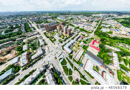 Aerial city view with crossroads and roads, houses, buildings, parks and parking lots. Sunny summer 46568379