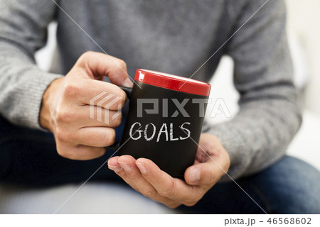 man with a mug with the word goals 46568602