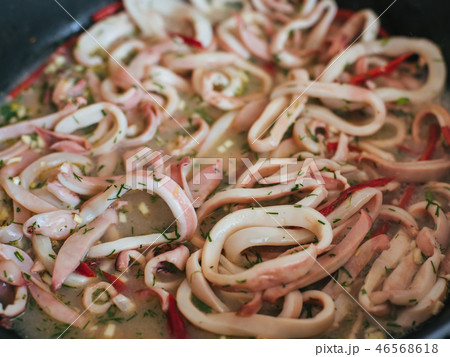 Squid rings are stewed in a pan 46568618