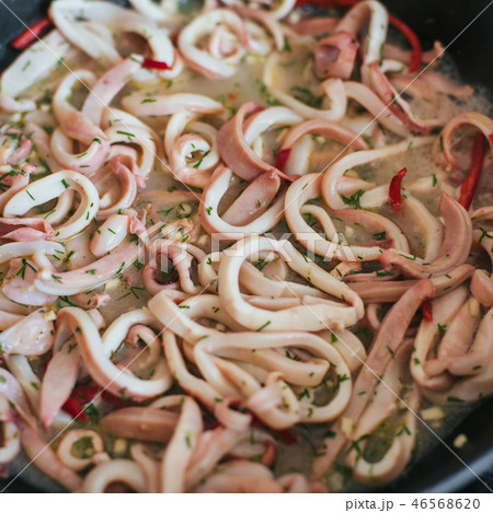 Squid rings are stewed in a pan 46568620