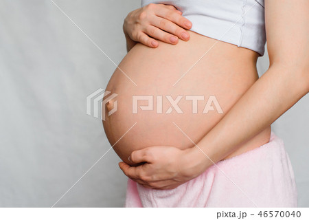 pregnant girl gently hugging her belly pregnant girl gently hugging her belly 46570040