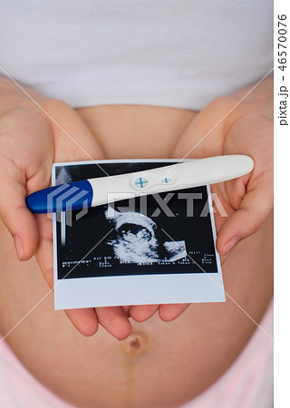 ultrasound picture and positive pregnancy test in the hands of a pregnant girl ultrasound picture and positive pregnancy test in the hands of a pregnant girl 46570076
