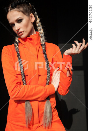 beautiful fashionable woman with braids in Orange overalls 46570156