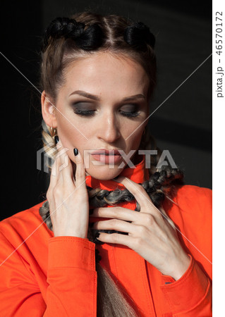 beautiful fashionable woman with braids in Orange overalls beautiful fashionable woman with braids in Orange overalls 46570172