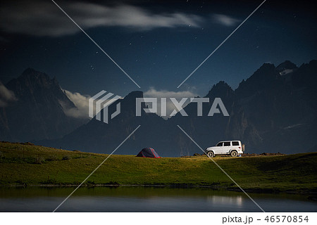 Camping with a car, tent at night with moonlight at mountain range 46570854