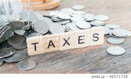 Taxes print text on wood square block Taxes print text on wood square block 46571726