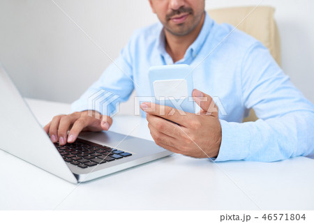 Businessman sitting at his workplace Businessman sitting at his workplace 46571804