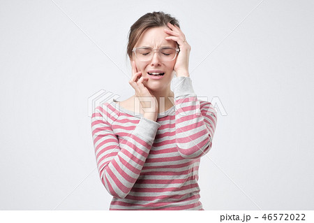 Portrait of displeased upset female frowns face as going to cry, being discontent and unhappy Portrait of displeased upset female frowns face as going to cry, being discontent and unhappy 46572022