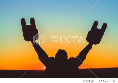 Hands with horns raised up in the standing  46572115