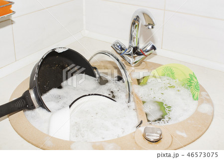 huge heap of dirty dishes waiting for the flatmate 46573075