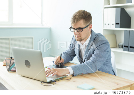 Designer, artist and web design concept - Portrait of young man using digital pen tablet and laptop 46573379