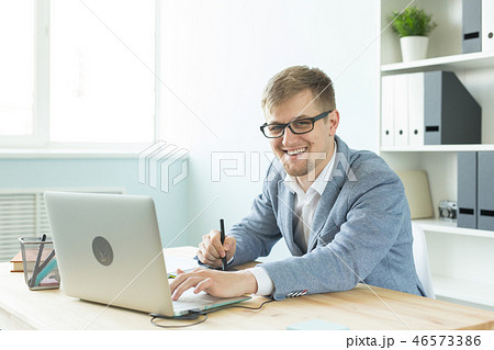 Designer, artist and web design concept - Portrait of young man using digital pen tablet and laptop Designer, artist and web design concept - Portrait of young man using digital pen tablet and laptop 46573386