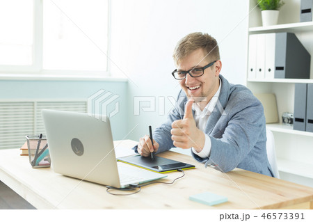 Designer, artist and web design concept - Portrait of young man using digital pen tablet and laptop Designer, artist and web design concept - Portrait of young man using digital pen tablet and laptop 46573391