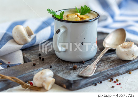 Homemade mushroom cream soup in an enamel mug. 46573722