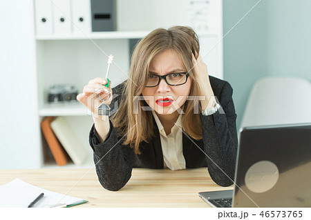 Business, realtor and negative emotions concept - Portrait of exhausted office worker woman holding Business, realtor and negative emotions concept - Portrait of exhausted office worker woman holding 46573765