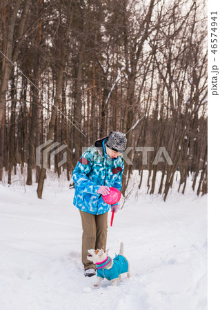 Middle aged woman outdoors with cute dog - Jack Russell Terrier in winter season Middle aged woman outdoors with cute dog - Jack Russell Terrier in winter season 46574941