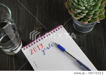 Top view of notebook with text 2019 goals  46575023