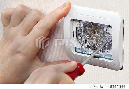 Mount wall light switch, hand with screwdriver 46575531