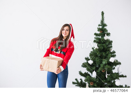 Christmas, xmas, new year and happiness concept - laughing caucasian woman in santa helper hat with Christmas, xmas, new year and happiness concept - laughing caucasian woman in santa helper hat with 46577064