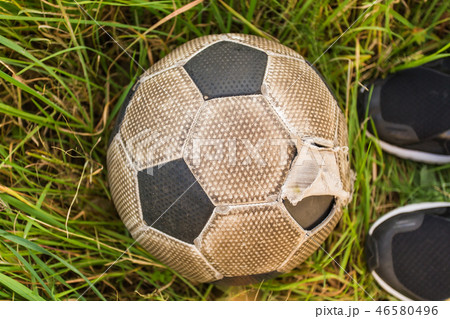 Old Soccer ball on the green grass, top view Old Soccer ball on the green grass, top view 46580496
