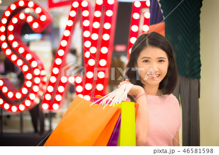 Young Woman holding fashion shopping bag in mall. Young Woman holding fashion shopping bag in mall. 46581598