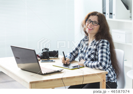 Illustrator, web designer and artist concept - Graphic designer using her pen tablet in a bright 46587074