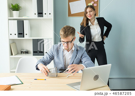Business, emotions and people concept - Disgruntled boss watch as the employee works. 46587205