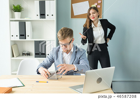 Business, emotions and people concept - Business woman shout at male worker in office place 46587208