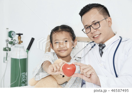 Young male doctor pediatrician checking girl Young male doctor pediatrician checking girl 46587495