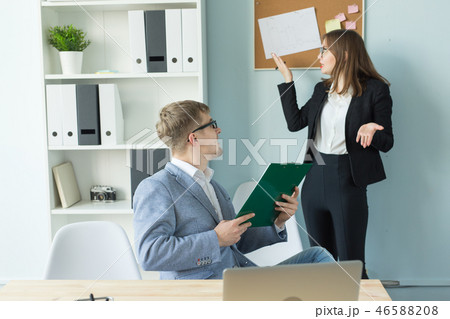 Business, team work and people concept - woman and man are discussing their project together in 46588208