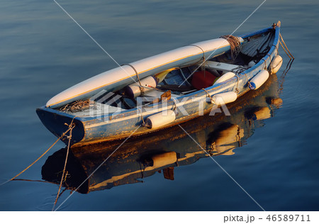 Boat with a kayak lying on it on lake Garda. 46589711