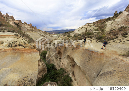 young couple of tourists stands on of canyon 46590409