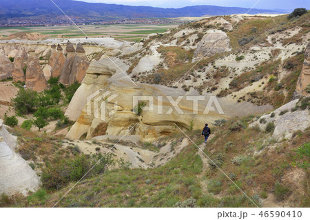 Tourist woman walks along the path of the canyon Tourist woman walks along the path of the canyon 46590410